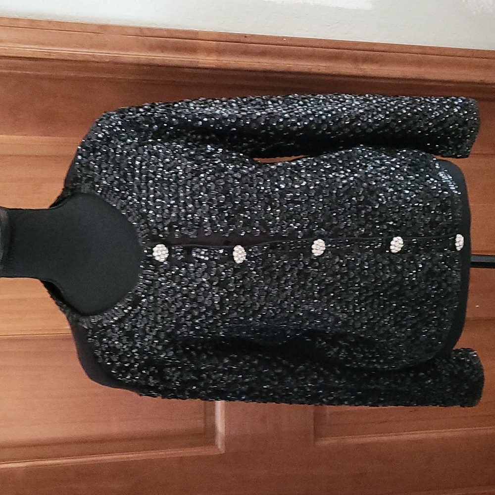 Sequin sweater with silver buttons down front of sweater.